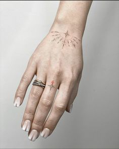 a woman's hand with an arrow tattoo on it