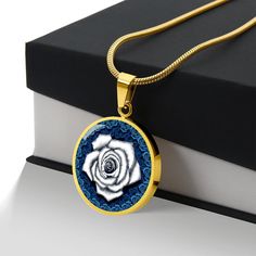 White Rose Circle Pendant Necklace If you're looking for a unique and meaningful gift for your loved one, consider the White Rose Circle Pendant Necklace. While red roses are commonly associated with love, white roses have their own symbolic meaning. In addition to love, white roses are also associated with feelings of affection, purity, innocence, spirituality, and loyalty. The patent-pending jewelry is made of high-quality surgical steel with a shatterproof liquid glass coating, and we have an Knot Stud Earrings, Knot Studs, Luxury Necklace, Circle Pendant Necklace, Glass Coating, Cubic Zirconia Earrings, Zirconia Earrings, Gold Dipped, Circle Pendant