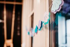 there are some paper garlands hanging on the wall