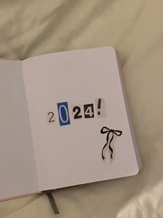 an open notebook with the number twenty four drawn on it