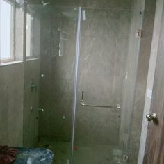 a bathroom with a walk in shower next to a window