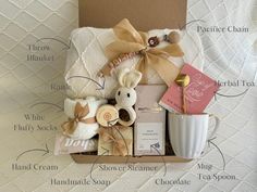 the contents of a baby gift box on a bed with its label labeled in english