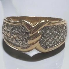 a close up of a gold ring on a white surface