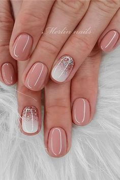 a woman's hands with pink and white nail polishes on their nails,