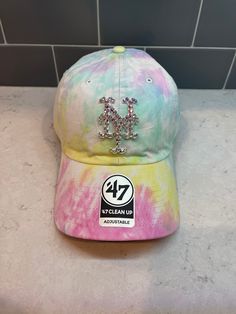 the 47 clean up hat is multicolored and has sequins on it