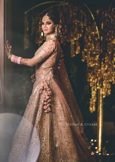 a woman in a bridal gown posing for the camera