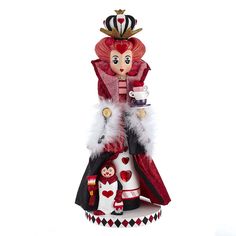 a figurine that is wearing a red and white dress with hearts on it