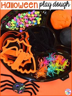 halloween play dough with sprinkles and spider on the plate next to it