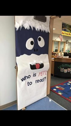 a classroom door decorated with an image of a cat and the words who is yet to read?