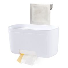 a white toilet paper dispenser next to a roll of tissue