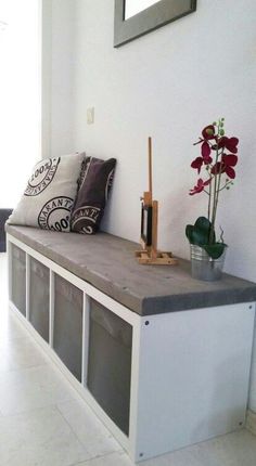 a bench with some flowers on top of it and a vase filled with red flowers