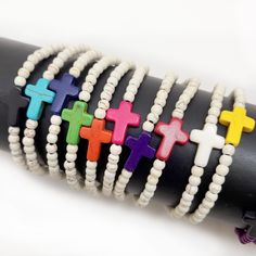 Style meets affordability. Express your faith with this Stone Cross Bracelet. This bracelet has been hand-crafted by skilled artisans and will make a nice addition to your collection. It is a perfect gift for Christmas, Easter,Halloween, Valentine's Day, Birthday, Father's Day, Mother's Day, Anniversary or any Special Event for your dad, mom, brother, sister, boyfriend, girlfriend, son, daughter, friend, roommate or classmate. ✦Gemstone: Magnesite Turquoise, Howlite Turquoise ✦Color:   Cross Color - 10 Colors   Black, Turquoise Blue, Navy Blue, Green, Orange, Red, Pink, Purple, White, Yellow   Round Bead - Ceam White ✦Shape: Smooth Round Beads + Cross Charm ✦Bead Size:   4mm Round Bead + 15x12mm Cross,   6mm Round Bead + 25x18mm Cross,   8mm Round Bead + 30x20mm Cross,  10mm Round Bead + 3 Adjustable Cross Jewelry With Wooden Beads, Adjustable Wooden Beads Cross Jewelry, Clay Bracelets, Stone Cross, Black Turquoise, Kids Bracelets, Beaded Cross, White Crosses, Turquoise Howlite