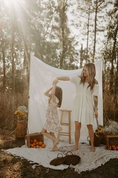 "Mother and child embrace in a dreamy #mommyandmephotoshoot surrounded by #orangesandflowers in #ocalaflorida. The warm colors and natural setting create a serene atmosphere, perfect inspiration for photographers and a heartwarming #mothersdaygiftidea. #motherhoodphotography #whitesheetphotos #familyphotography #bondingmoments #preciousmemories #photographyinspiration #beautifulbackdrops #scenicbeauty" Outdoor Photoshoot Backdrop, White Sheet Backdrop, Sheet Backdrop, Fall Mini Shoot, Mini Shoot Ideas, Sheet Photoshoot, Mommy And Me Photoshoot, New Year Photoshoot, Fall Minis