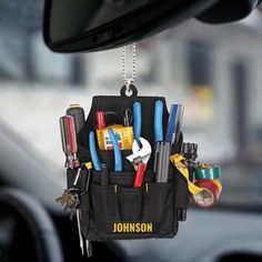 a car key holder with tools hanging from it's back pocket in the dashboard