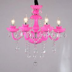 a pink chandelier with five lights hanging from it's center and two candles on each side