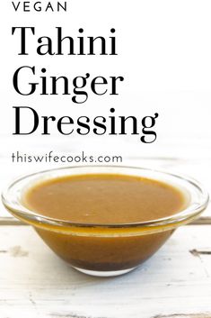 a glass bowl filled with ginger dressing on top of a white wooden table next to the words vegan tahitii ginger dressing