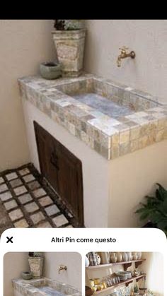 a bathroom sink sitting under a window next to a potted plant