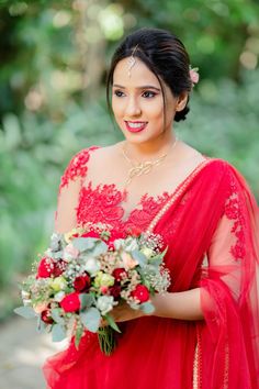 a woman in a red dress holding a bouquet