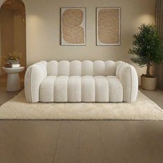 a white couch sitting on top of a rug in a living room