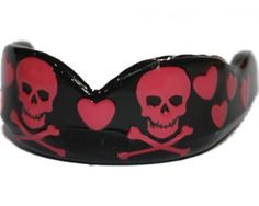 a skull and crossbones bracelet with red hearts on black rubber wristbands