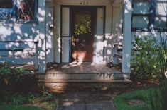 the front door of a white house is open