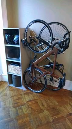 a bike mounted to the side of a wall with two bikes on it's back