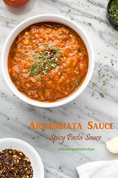 an overhead view of a bowl of arrabatta sauce on a marble table