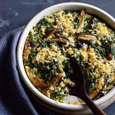 a casserole dish with spinach and mushrooms