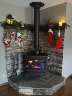 a fireplace with stockings hanging on the mantle and christmas stockings hung over it's fire