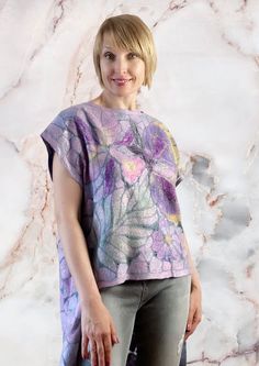 a woman standing in front of a marble wall