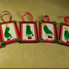 four handmade christmas ornaments are displayed on a table with red and green trimmings