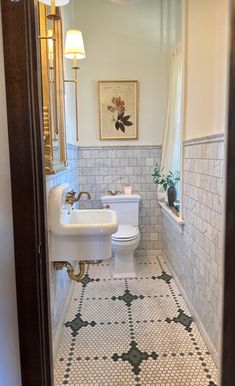 a white toilet sitting in a bathroom next to a sink