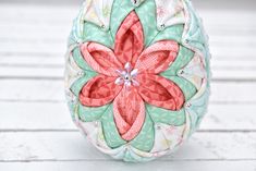 an ornament made out of fabric with flowers on it