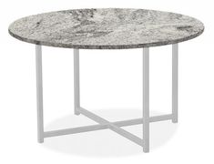 a white marble table with metal legs and a round design on the top is shown