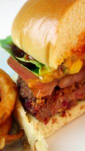 a close up of a sandwich and some onion rings