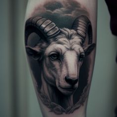 a goat tattoo on the leg with clouds in the background