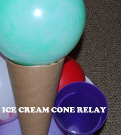 an ice cream cone sitting on top of a table next to other plastic cups and containers