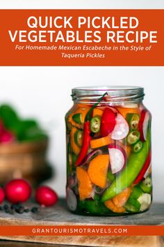 a jar filled with vegetables sitting on top of a wooden table