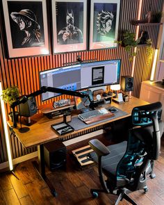 a computer desk with two monitors and a keyboard on it in front of three pictures