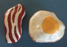 two bacon and an egg on top of each other, one is red and the other is white