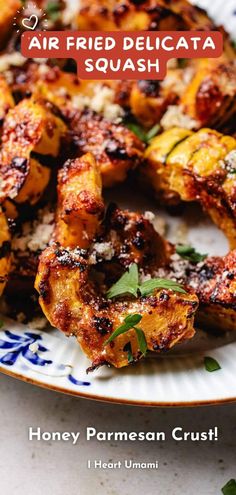 the cover of an air fried delicata squash recipe on a blue and white plate