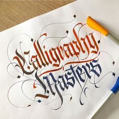 an artistic calligraphy art piece is shown with a marker and pen on top of it