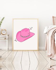 a pink hat is on the floor next to a white wall and a bed with pillows