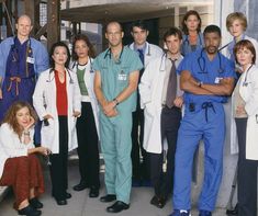 a group of doctors standing in front of a building