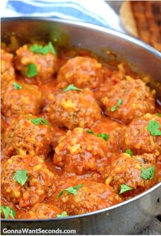 meatballs with tomato sauce and parsley in a pan