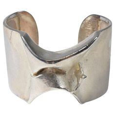 This bracelet is part of the space silver series by Bjorn Weckstrom for Lapponia. This design was called the "Man from Mercury". This Scandinavian modern cuff bracelet is marked 925 Sterling and Finland on the inside of the cuff. There is some tarnishing and weighs 68 grams. 1 9/16" wide x 6" circumference (without the opening) x 1" opening Contemporary Formal Cuff Bracelet Bangle, Modern Silver Bangle With Polished Finish, Modern Sterling Silver Oyster Bracelet For Formal Occasions, Modern Polished Sterling Silver Bangle Bracelet, Modern Polished Sterling Silver Bracelet, Contemporary Formal Bracelet With Oyster Design, Modern Polished Sterling Silver Bangle, Modern Sterling Silver Bangle With Polished Finish, Modern Silver Bangle For Formal Occasions