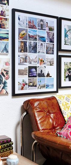 a brown leather couch sitting next to a wall covered in pictures