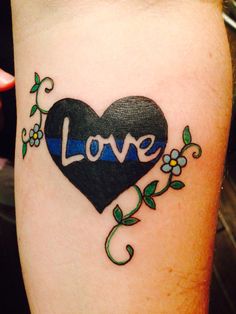 a tattoo with the word love and a thin blue line in the shape of a heart