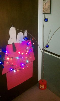 a door decorated with christmas lights and an ornament on the front side of it