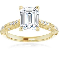 an emerald cut diamond engagement ring set in yellow gold